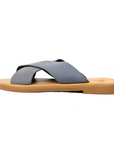 Theluto Gaelle slip-on sandals featuring soft grey leather crisscross straps and a comfortable tan cushioned sole.