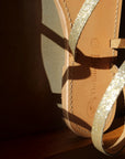 Theluto Lilou glitter sandals handcrafted from natural leather with a shimmering gold strap and stitched sole