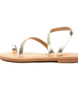 Theluto Lilou handcrafted gold leather sandals with a minimalist toe-ring design and flat sole, side view.