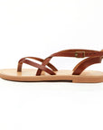 Theluto Marie brown leather flat sandals with minimalist crisscross straps and an adjustable ankle buckle