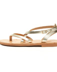 Theluto Marie metallic gold leather flat sandals with a minimalist strappy design and adjustable ankle buckle