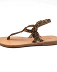 Theluto Meloe Cheetah leather thong sandal with leopard print straps, ankle buckle, and flat tan leather sole.
