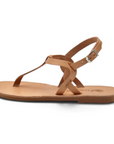 Theluto Meloe tan leather flat sandal with a delicate ankle strap and buckle closure, handmade in Greece.