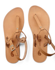 Theluto Meloe tan leather thong sandals with adjustable ankle straps and a minimalist handmade design.