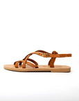 Theluto Valentine tan leather slip-on sandals with crisscross straps and gold buckle, handmade in Greece.