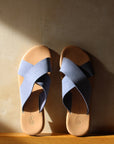 Theluto Gaelle blue leather slip-on sandals with a crisscross strap design and cushioned tan footbed