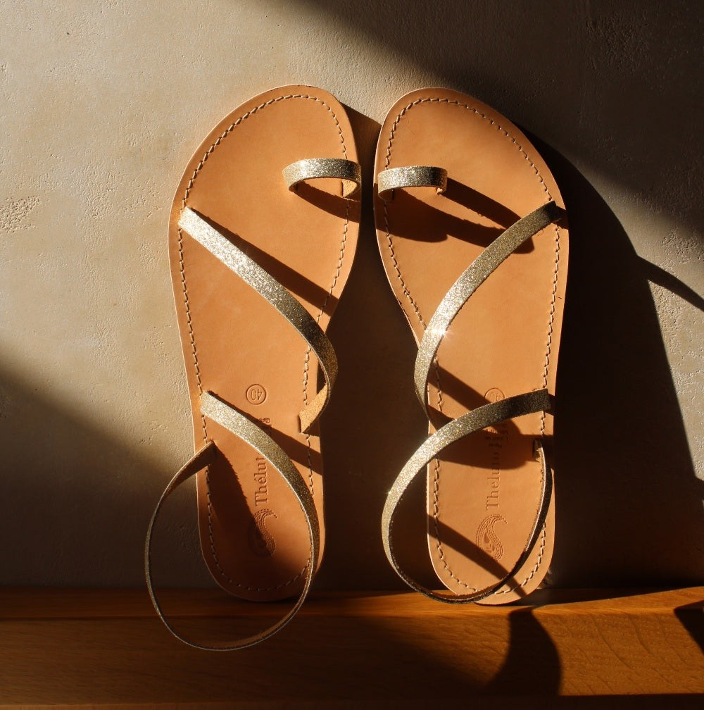 Theluto Lilou glitter sandals in gold leather with a toe loop design, handcrafted in Greece.