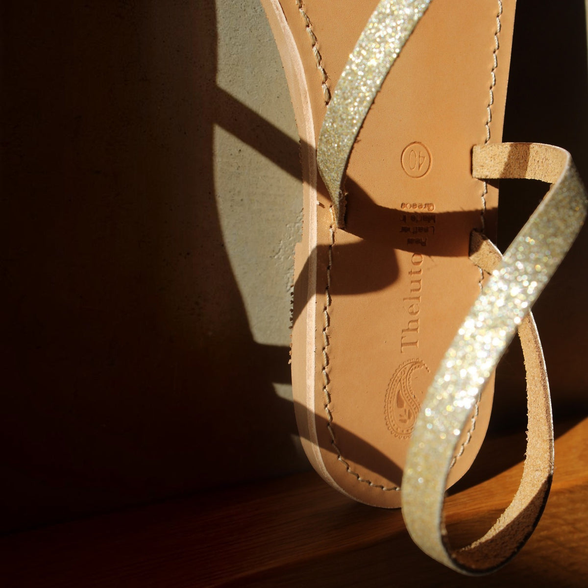 Theluto Lilou glitter sandals handcrafted from natural leather with a shimmering gold strap and stitched sole