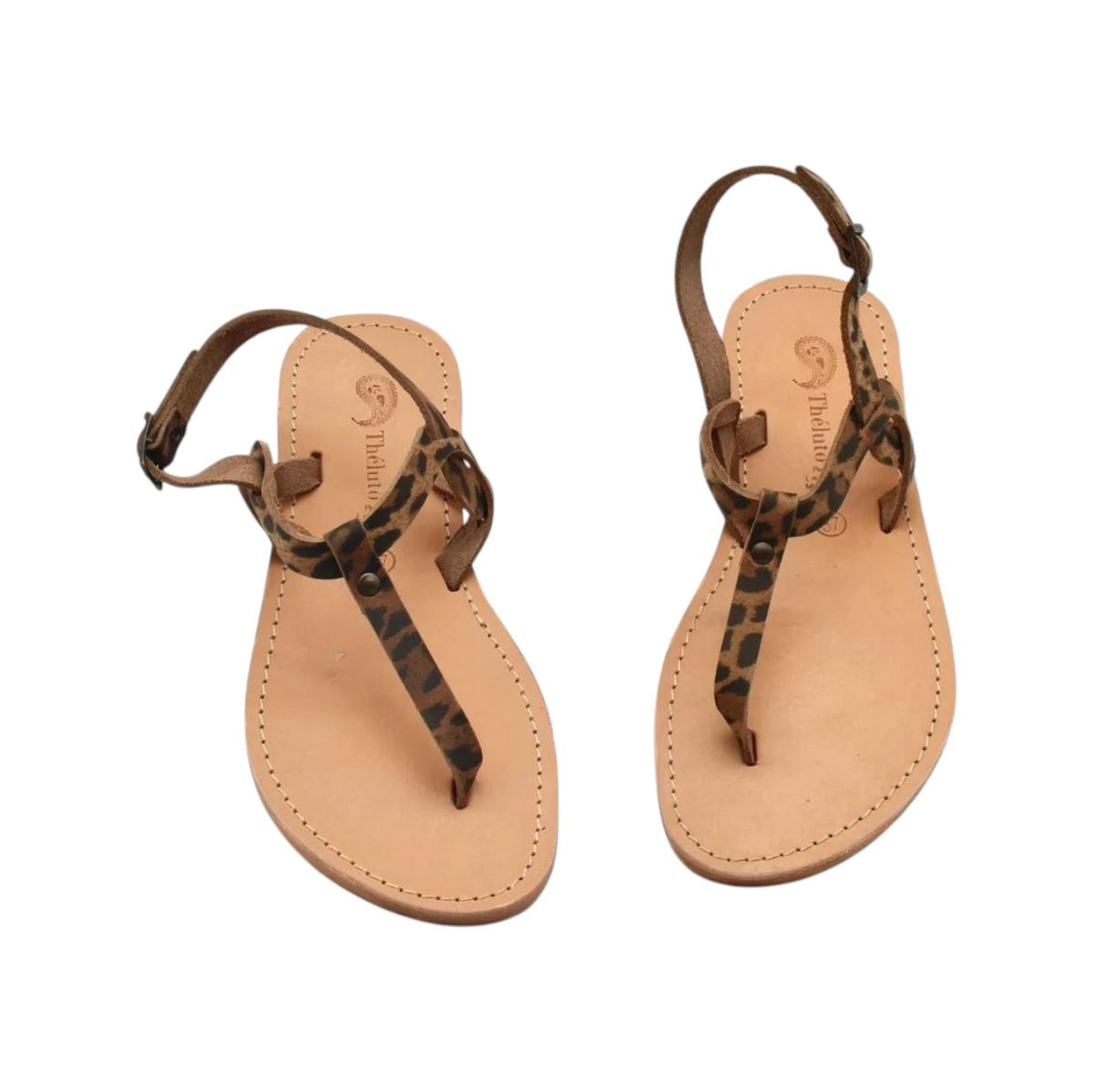 Theluto Meloe Cheetah leather sandals with leopard print straps, ankle ties, and a natural tan leather sole.