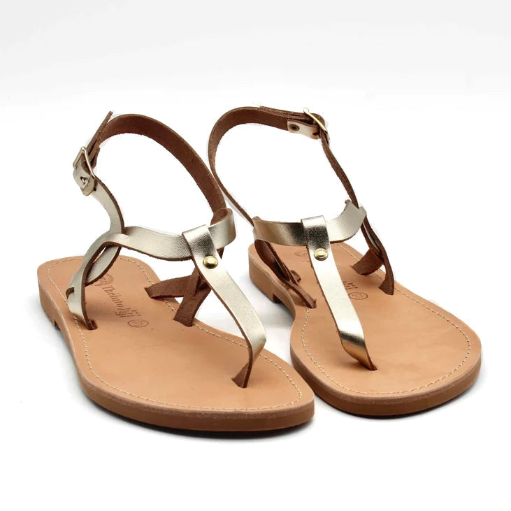 Theluto Meloe leather sandals featuring metallic gold straps, brown leather soles, and adjustable ankle buckles.