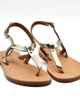 Theluto Meloe leather sandals featuring metallic gold straps, brown leather soles, and adjustable ankle buckles.