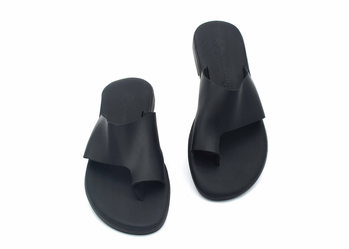 Theluto Mykonos black leather slip-on sandals with a toe loop design, featuring a comfortable reinforced sole.