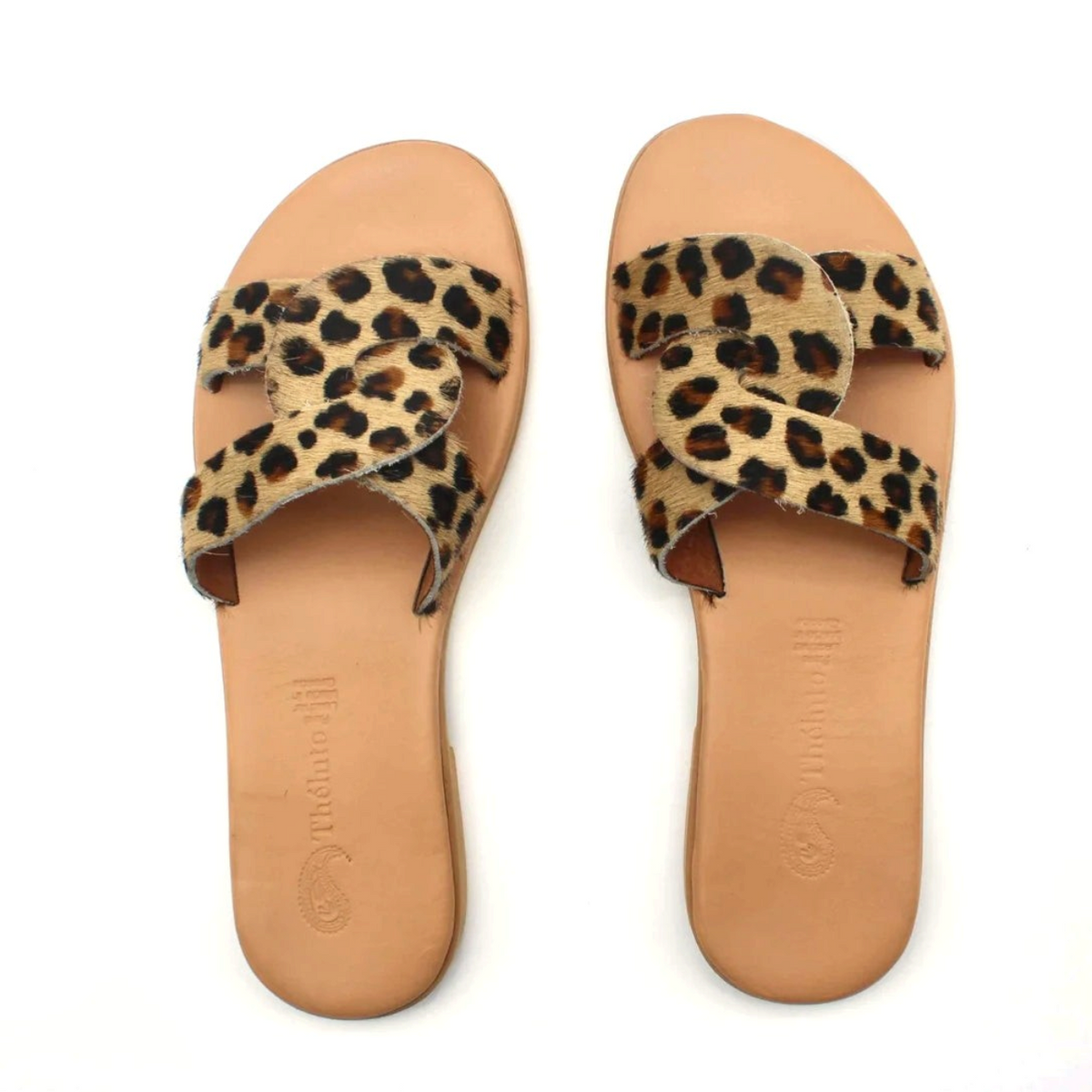 Theluto Prune Cheetah slip-on sandals featuring a bold animal print leather strap and a natural leather sole.