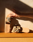 Theluto Prune Cheetah slip-on sandals featuring a tan leather sole and a stylish cheetah-print leather strap.