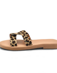Theluto Prune Cheetah slip-on sandals featuring a bold animal print leather strap and a natural leather sole.