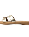 Theluto Prune slip-on sandals in metallic gold leather with a minimalist two-strap design, handmade in Greece.