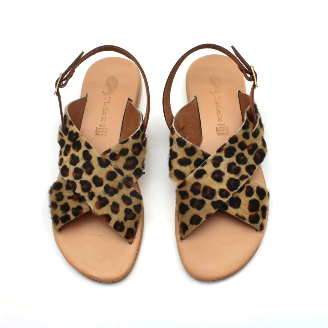 Theluto Tom Cheetah sandals featuring crisscross leopard print hair-on-hide leather straps and tan leather footbeds.