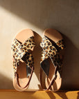 Theluto Tom Cheetah sandals featuring leopard print leather crisscross straps and a minimalist tan leather sole.