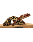 Theluto Tom Cheetah sandals featuring leopard print leather crossover straps and a brown ankle buckle on a flat sole.