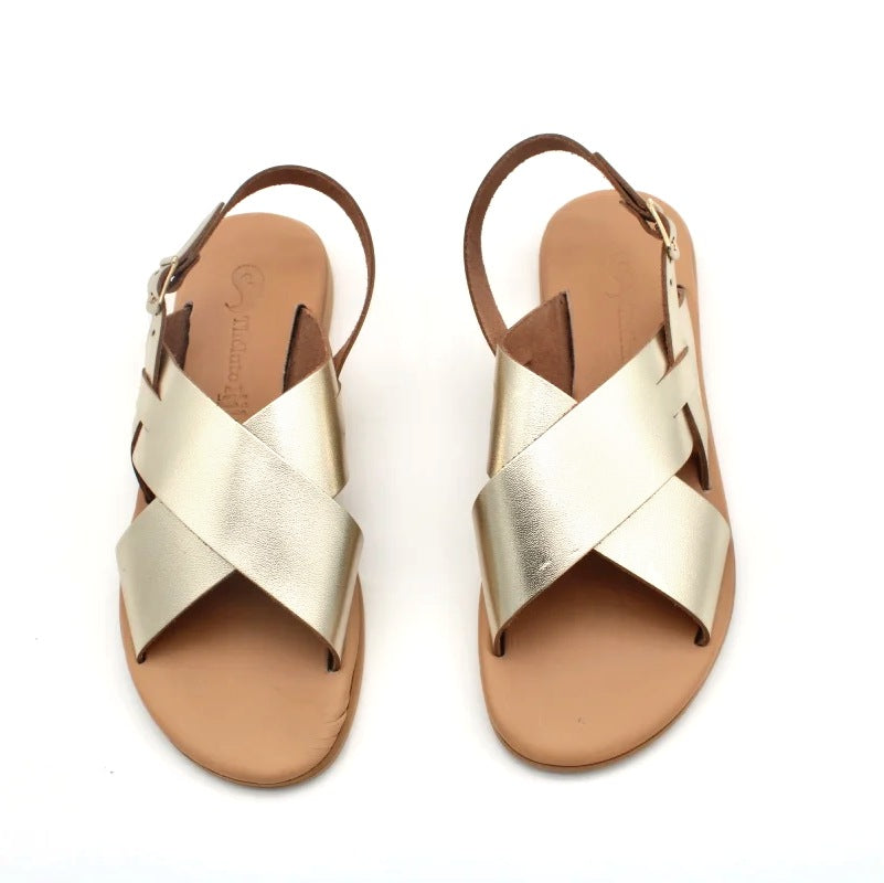 Theluto Tom gold metallic leather sandals with minimalist crisscross straps and an adjustable ankle buckle