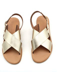 Theluto Tom gold metallic leather sandals with minimalist crisscross straps and an adjustable ankle buckle
